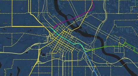 A map of a city with roads displayed as yellow lines and transit routes marked by green, blue, and red lines