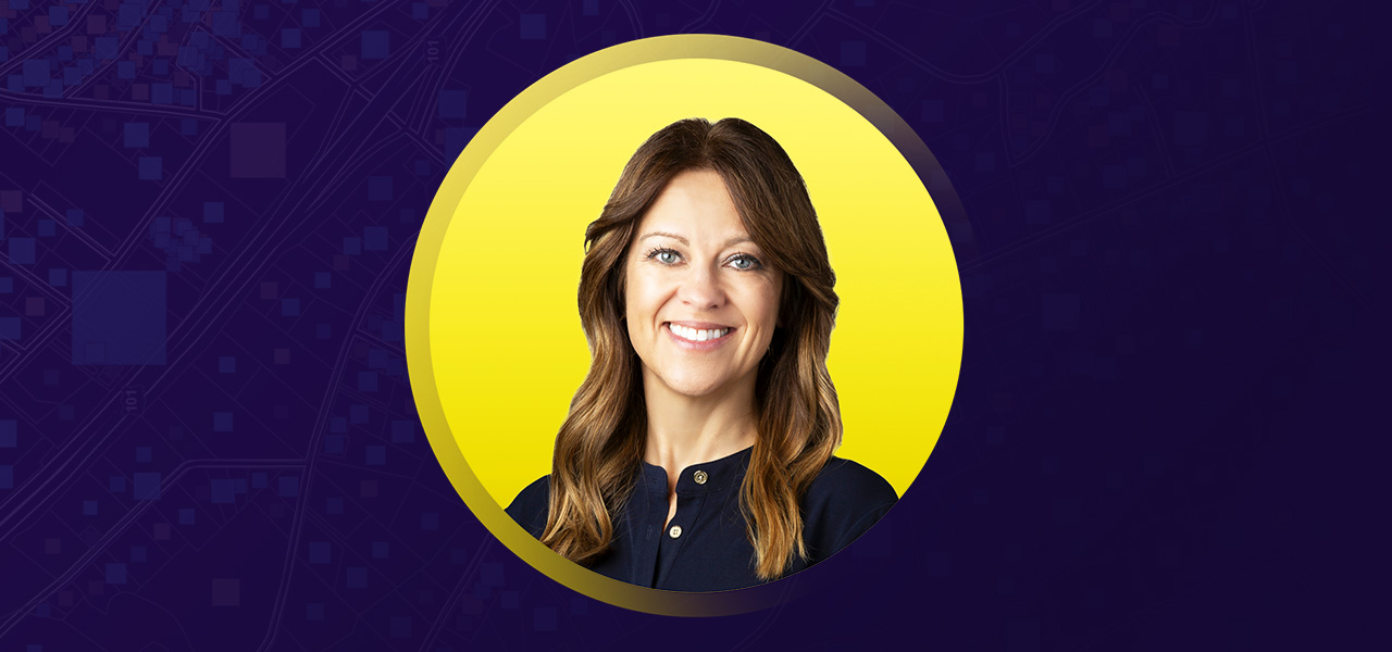 Portrait of Amy Simonsen smiling in a dark blue shirt