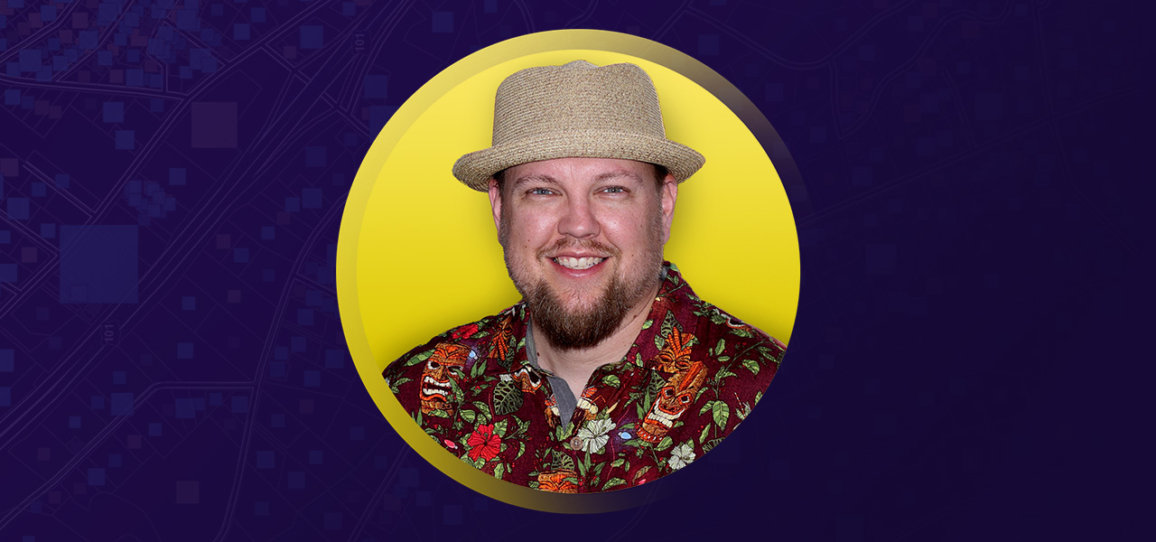 Damon Nelton smiling and wearing a hat and dress shirt overlaid on a yellow and purple graphic background