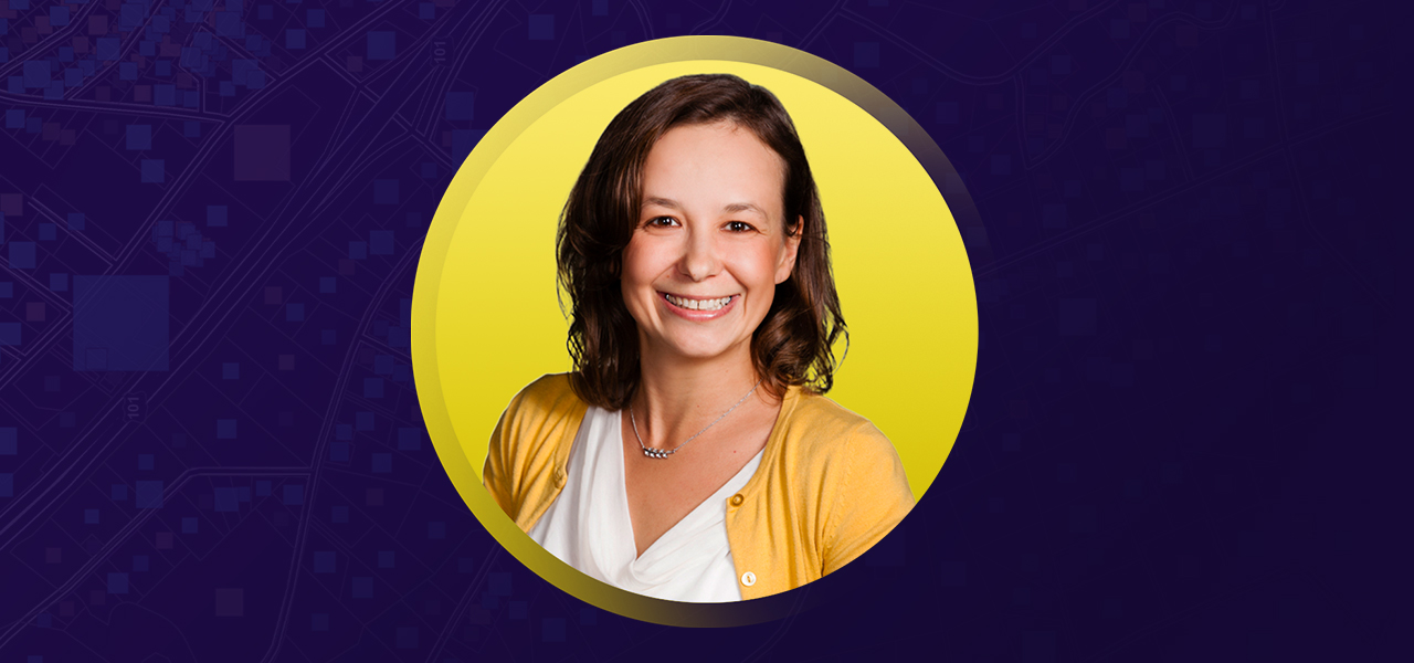 Lumi Matthys smiling and wearing a cardigan overlaid on a yellow and purple background