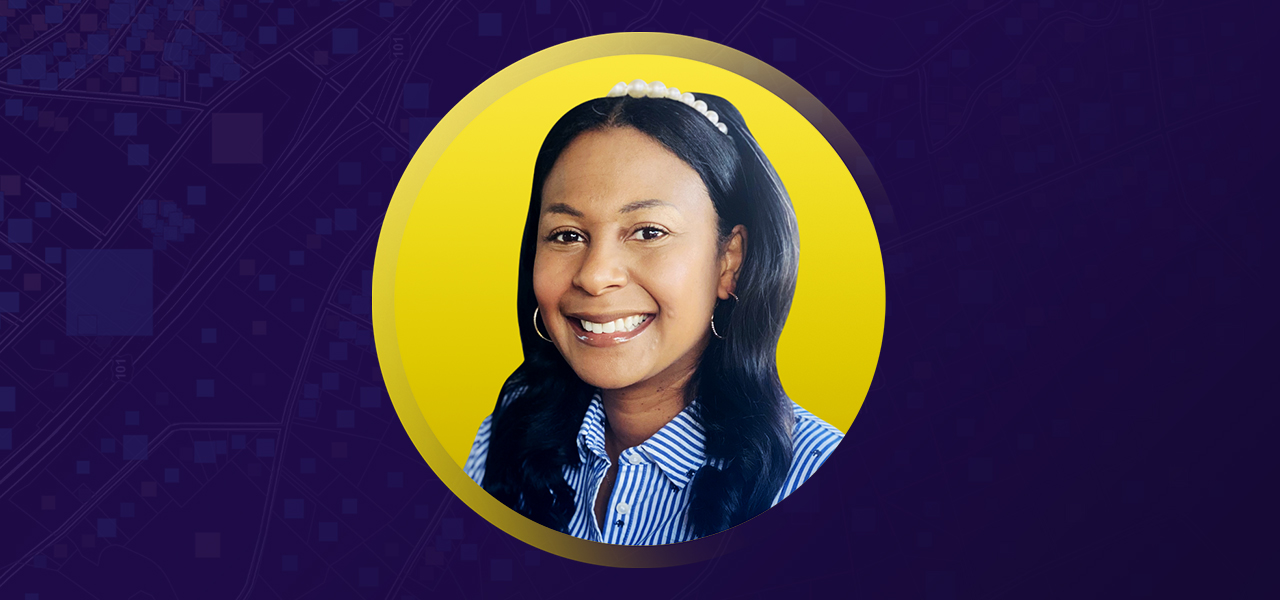 A portrait of Tamera Harris smiling, enclosed in a yellow circle on a purple background