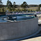 Two large open concrete tanks of water at a water treatment plant