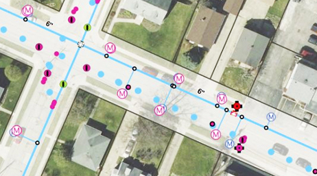 An aerial view of a residential neighborhood overlaid with a data layer that shows locations of water utility assets
