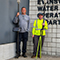 Four EWSU staffers, some in safety gear, pose with equipment outside the EWSU main department entrance