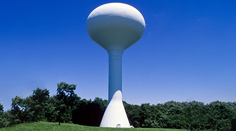 Water tower next to trees