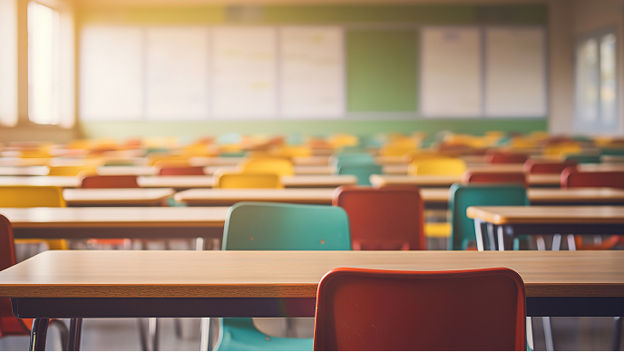 Rows of desks and chairs in an empty classroom