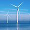 An offshore wind farm with five turbines on a clear day