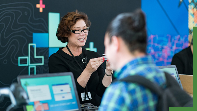 Two attendees signing up for usability research at computers during the Esri User Conference