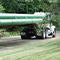 A semi-truck with a trailer transporting eight pipelines