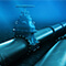 Underwater pipelines with a shut off value and light reflecting off the pipes from the sun above