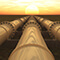 Three pipelines in field facing the sunset