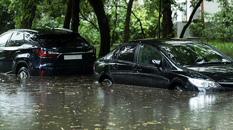 A flooded street with parked cars