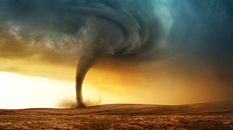 A tornado swirling across an open plain