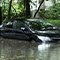 A flooded street  with parked cars