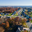 Aerial image of a residential neighborhood filled with tidy white houses and autumn trees