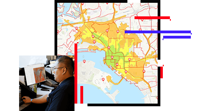A map with location pins and colored sections, and a person sitting at a desk working on a computer displaying a map