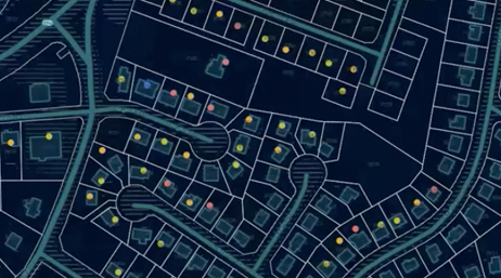 A dark map outlining a neighborhood with different color dots of on certain homes
