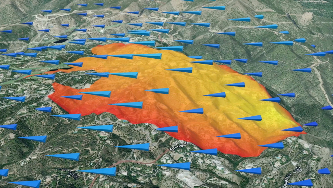 A 3D map showing a wildfire heatmap on a mountain, with blue arrows indicating wind direction and flow across the landscape