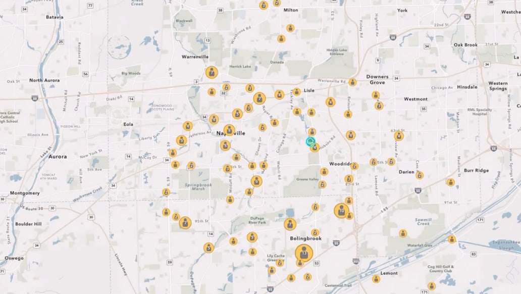 A city map with dozens of yellow point markers clustered across streets and neighborhoods, indicating many locations