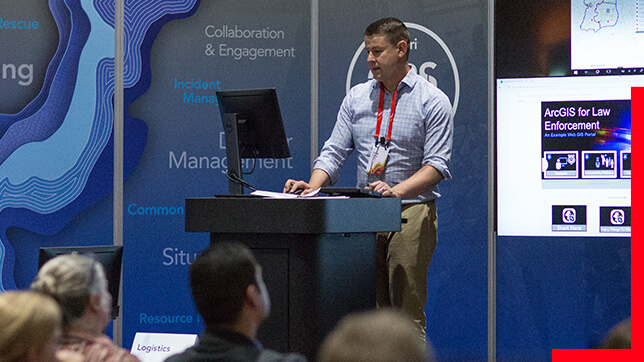 Person presenting on GIS in front of a seated audience