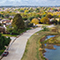 A bird’s eye view of a residential neighborhood dotted with green trees
