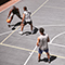 A group of people playing basketball outside