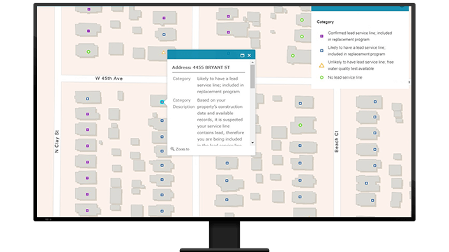 Um gráfico de um monitor de computador exibindo um mapa de bairro com um ponto em cada casa, um dos quais projetando um pequeno menu de dados da propriedade