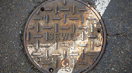 A sewer manhole in a street