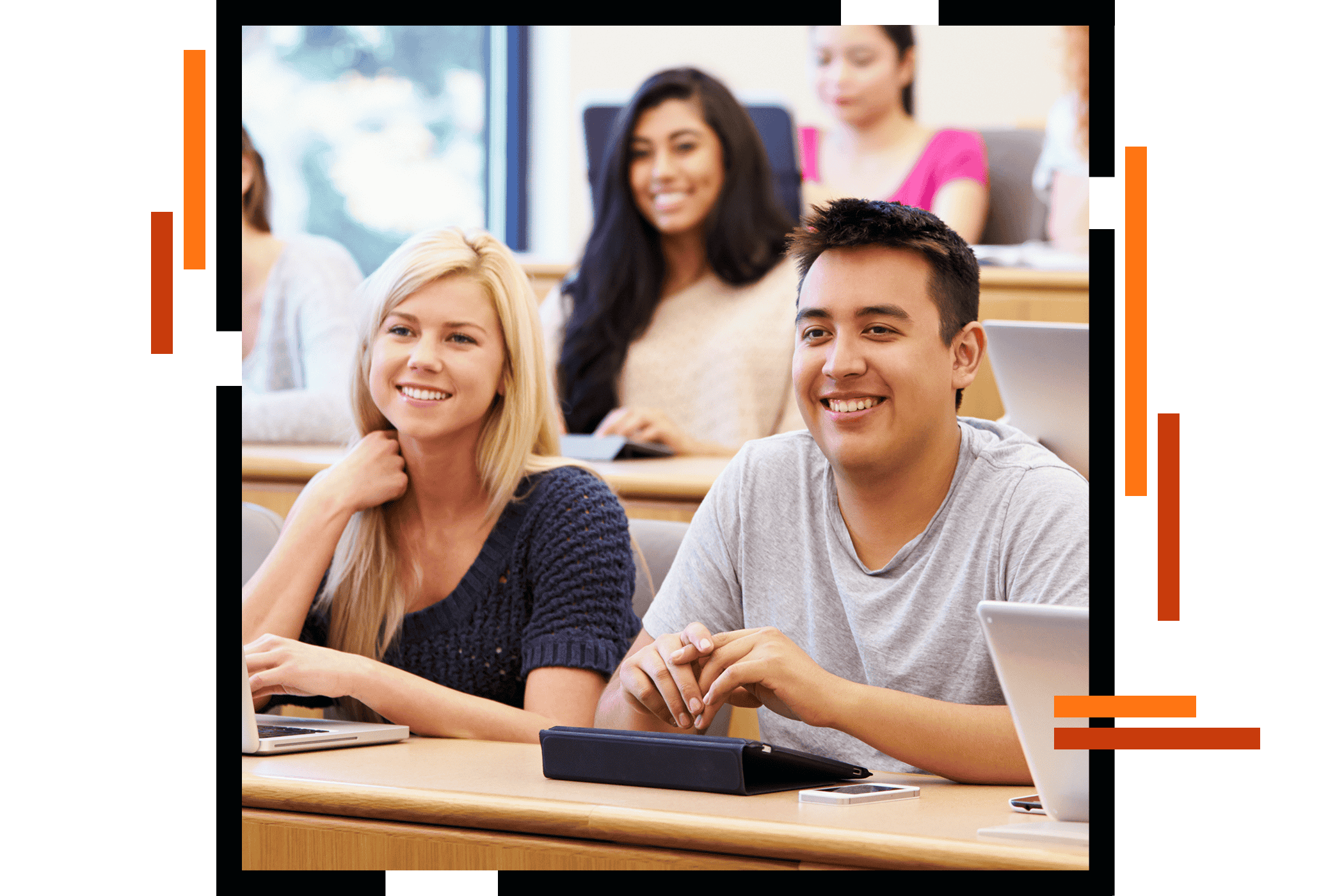 Young adult students with laptops and tablets sitting in a lecture hall and smiling