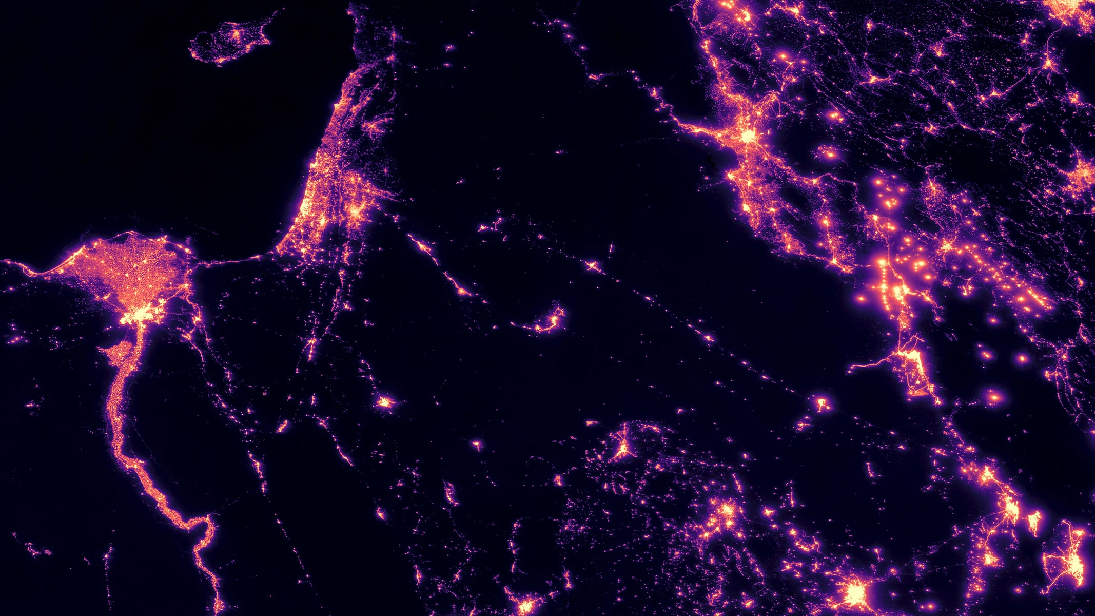 A satellite-style nighttime view showing illuminated cities and transportation networks