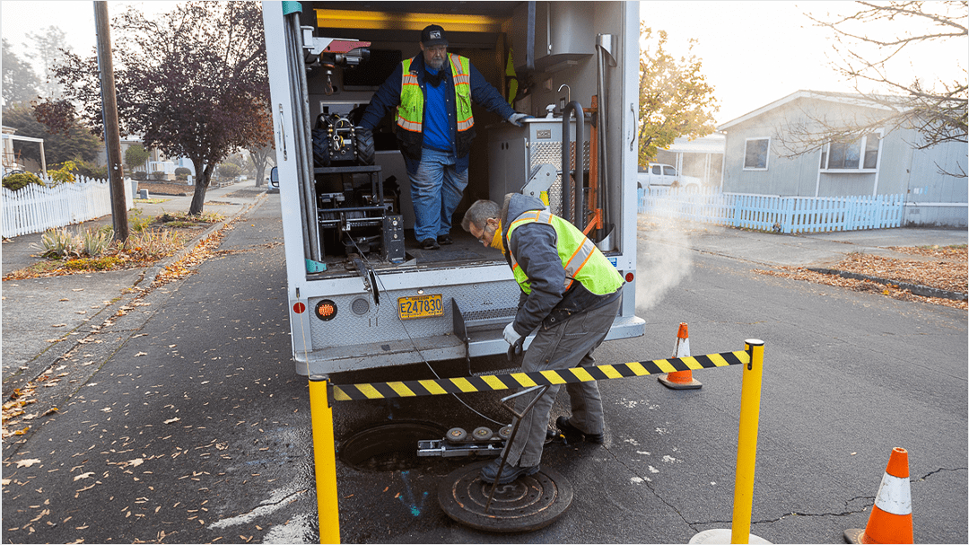 A crew sets up for a sewer inspection.