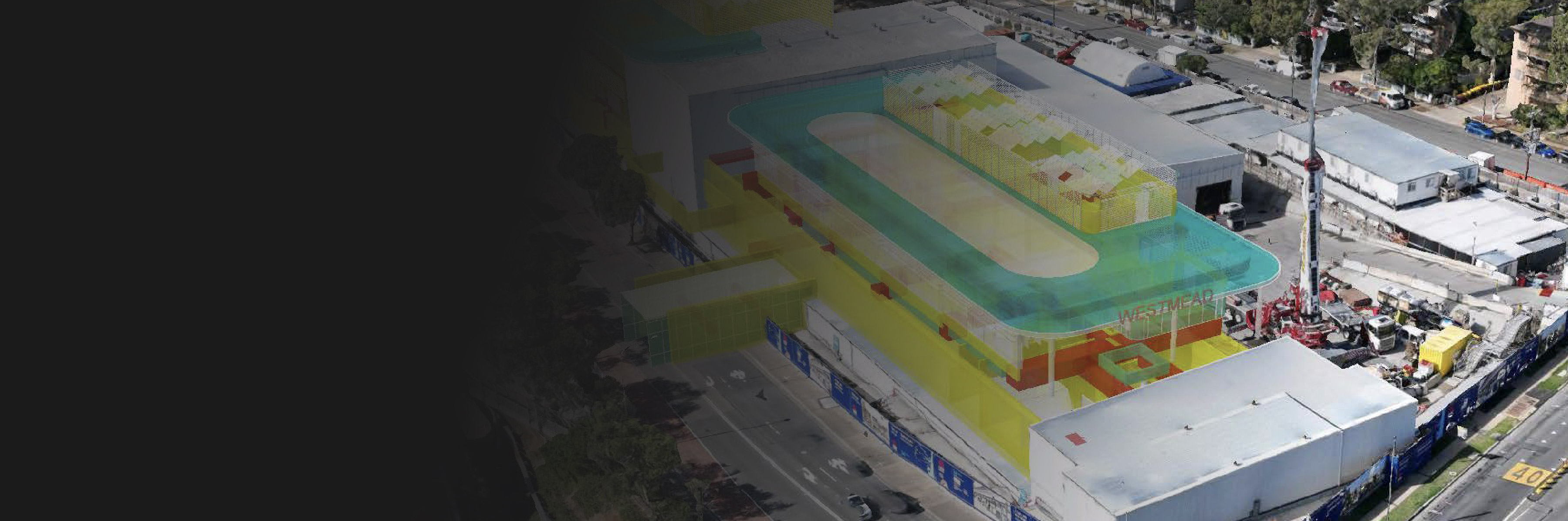 Aerial image of an industrial complex overlaid with a colorful 3D model displaying potential construction