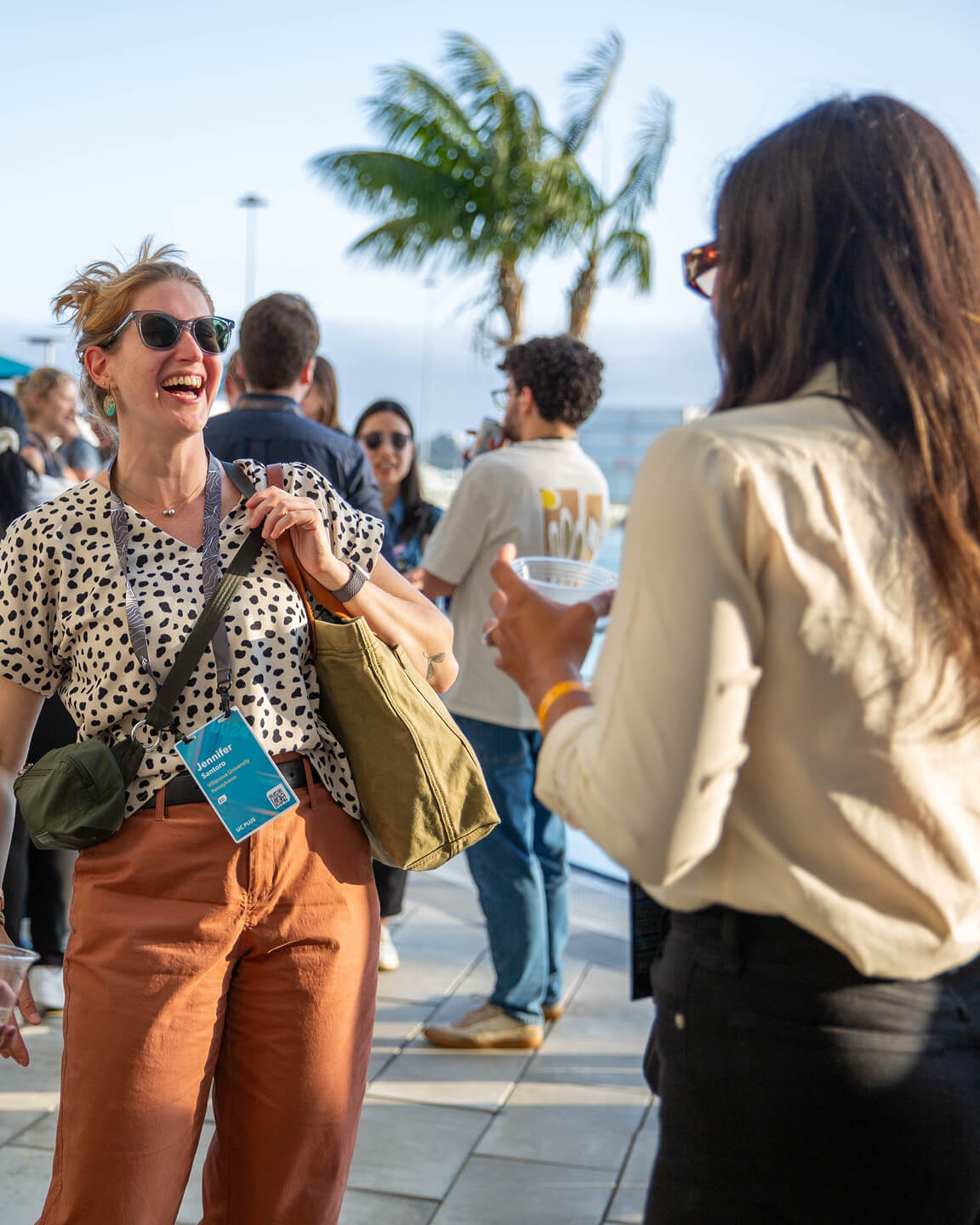 Two people talking and laughing at an outdoor event