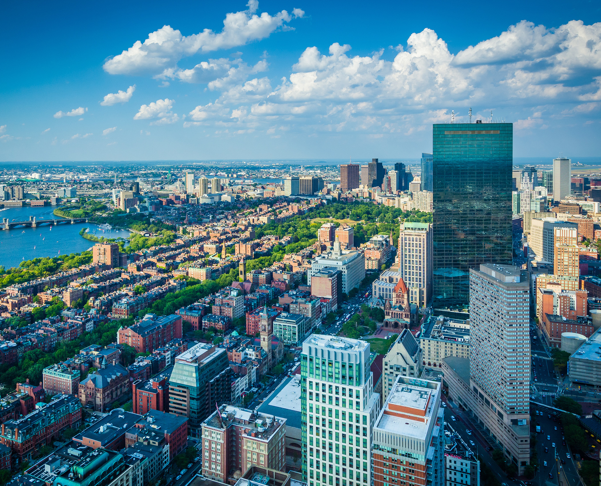 Aerial view of ta neighborhood in Boston, Massachusetts, with a dense collection of buildings, including John Hancock Tower and Boston Common