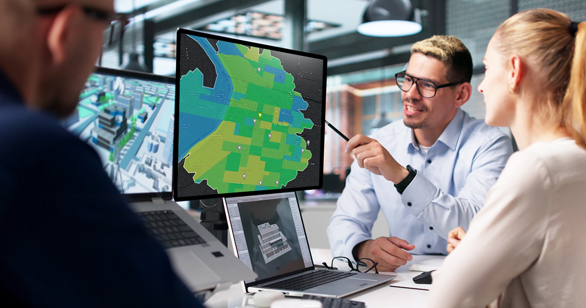 Business and government professionals looking at a parcel map on a monitor.