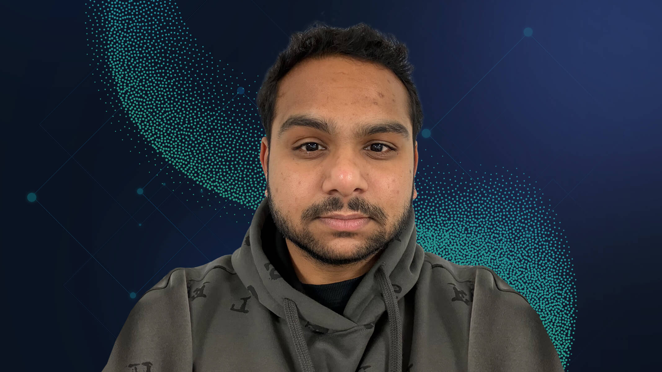 Portrait of Vikram Ponnuswamy in a stylized gray hooded sweatshirt with an abstract green graphic background