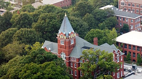 An aerial view of a few college buildings surrounded by tall trees at Georgia Institute of Technology