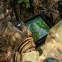 Close view of a soldier’s gloved hands holding a tablet