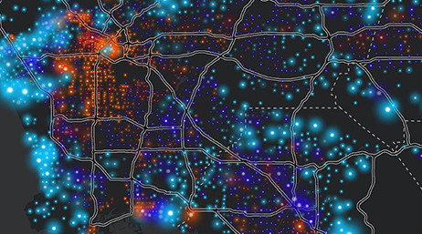 Black background map showing roads and points styled with orange, red, and blue dots 