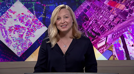 Esri’s Madeline Schueren wearing a black blouse and giving a presentation at the 2021 Esri User Conference