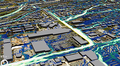 An aerial view of a gray 3D city model with potential flood patterns marked in white and aqua blue running through streets and between buildings