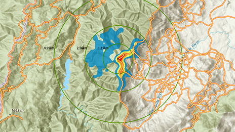 A contour map of a green mountainous area with an active fire perimeter in red and yellow