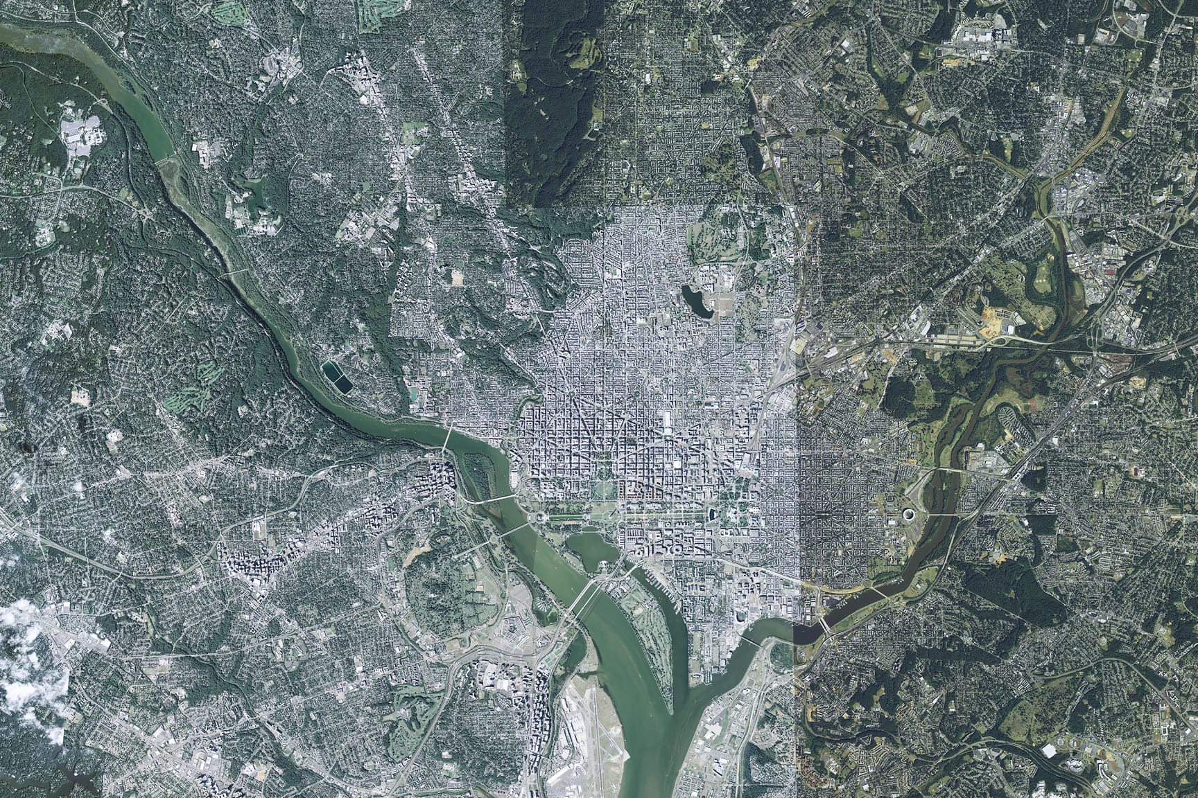 A detailed satellite image captures a sprawling urban area surrounded by rivers and dense greenery. 