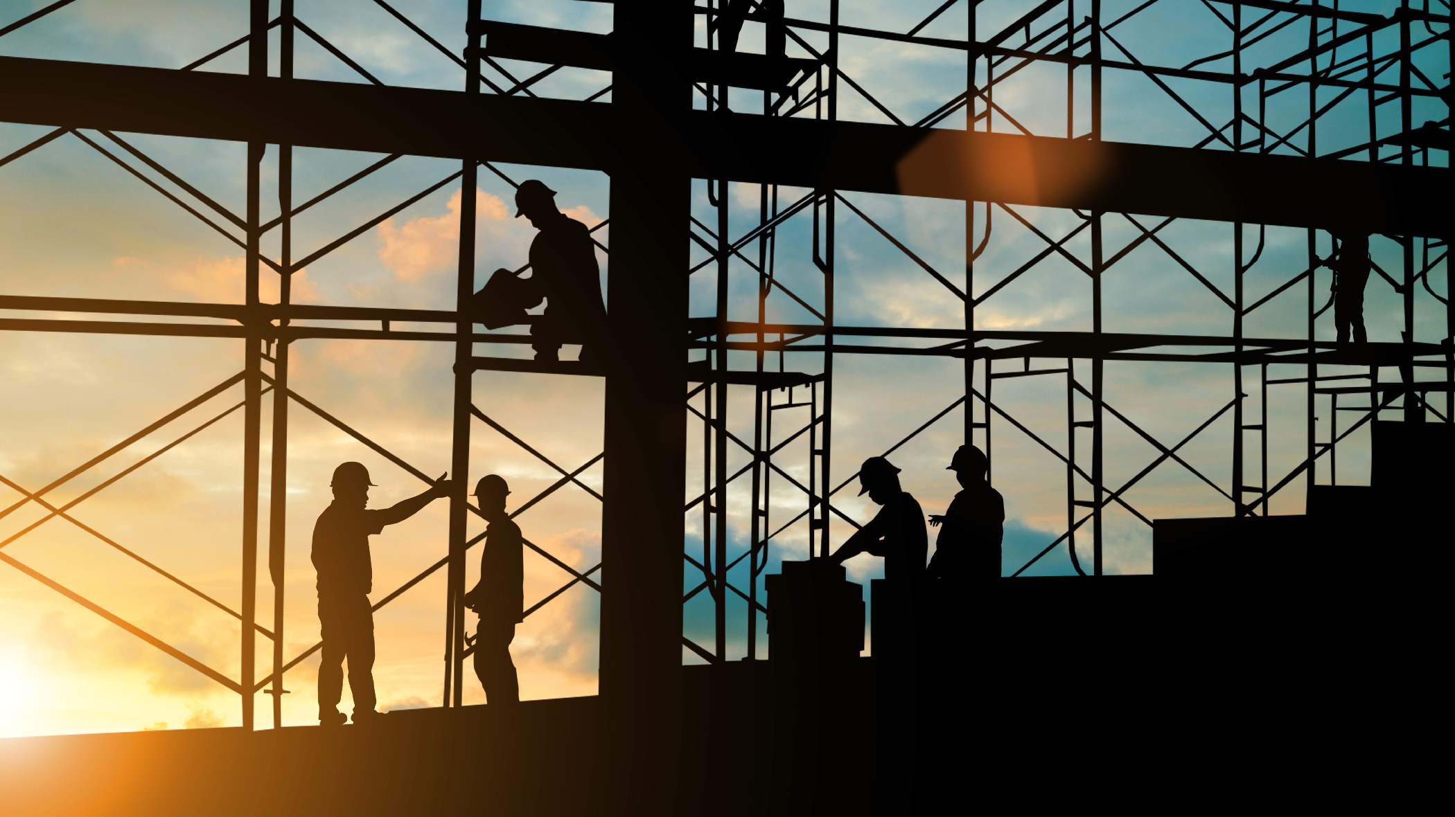 Silhouette engineer standing orders for construction crews to work on