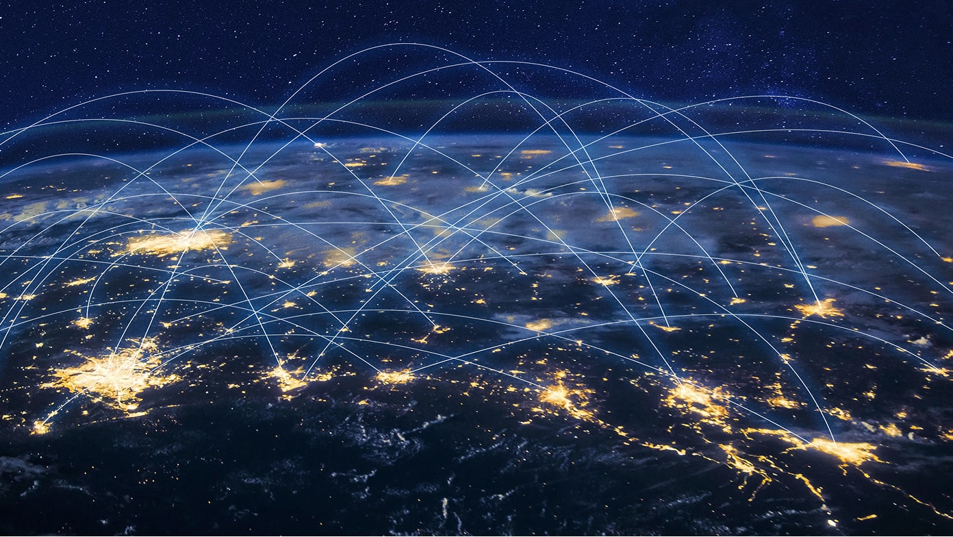 A satellite-style view of Earth at night shows illuminated cities connected by glowing blue arcs
