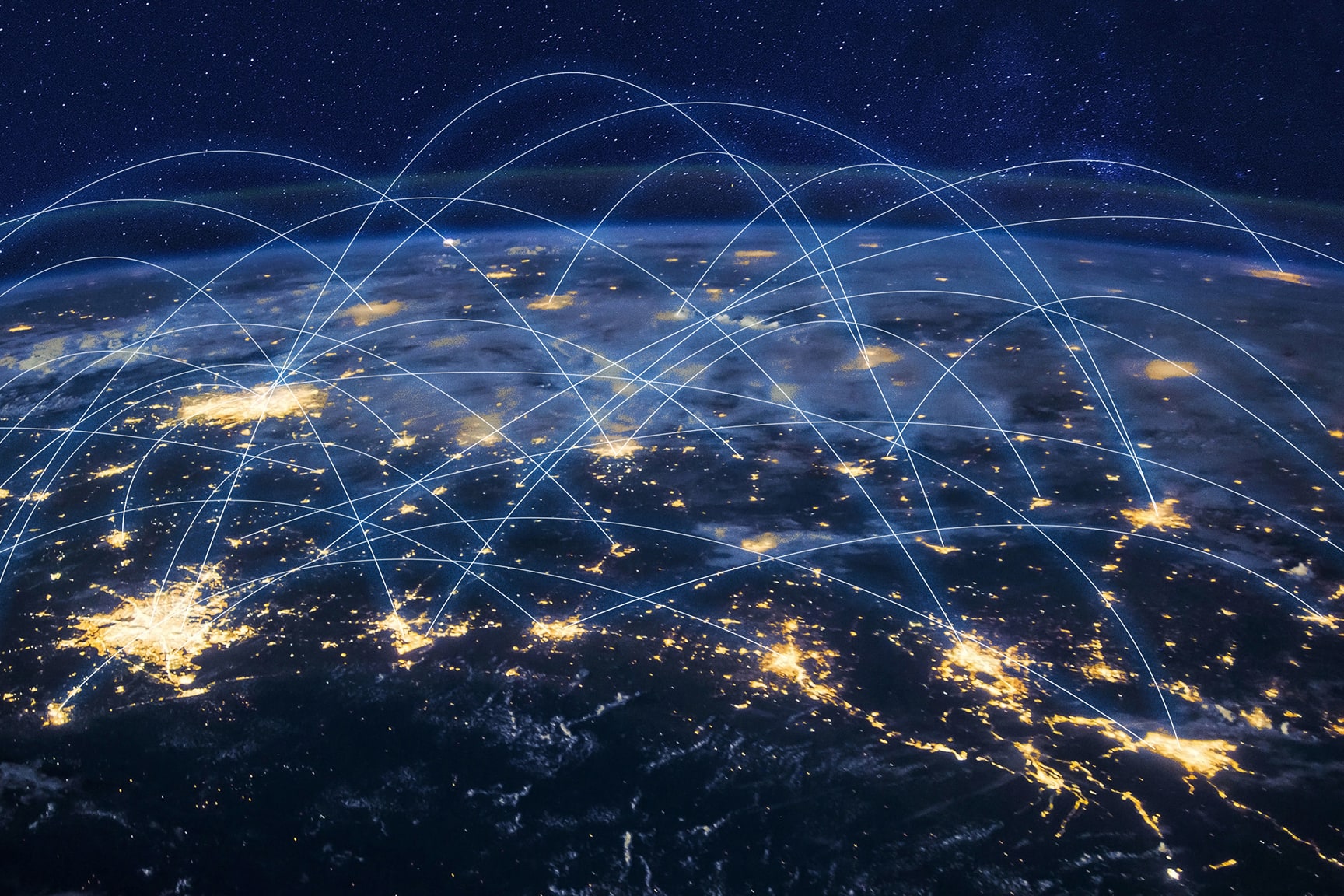 A view of Earth at night shows illuminated cities connected by glowing blue arcs representing a global digital network