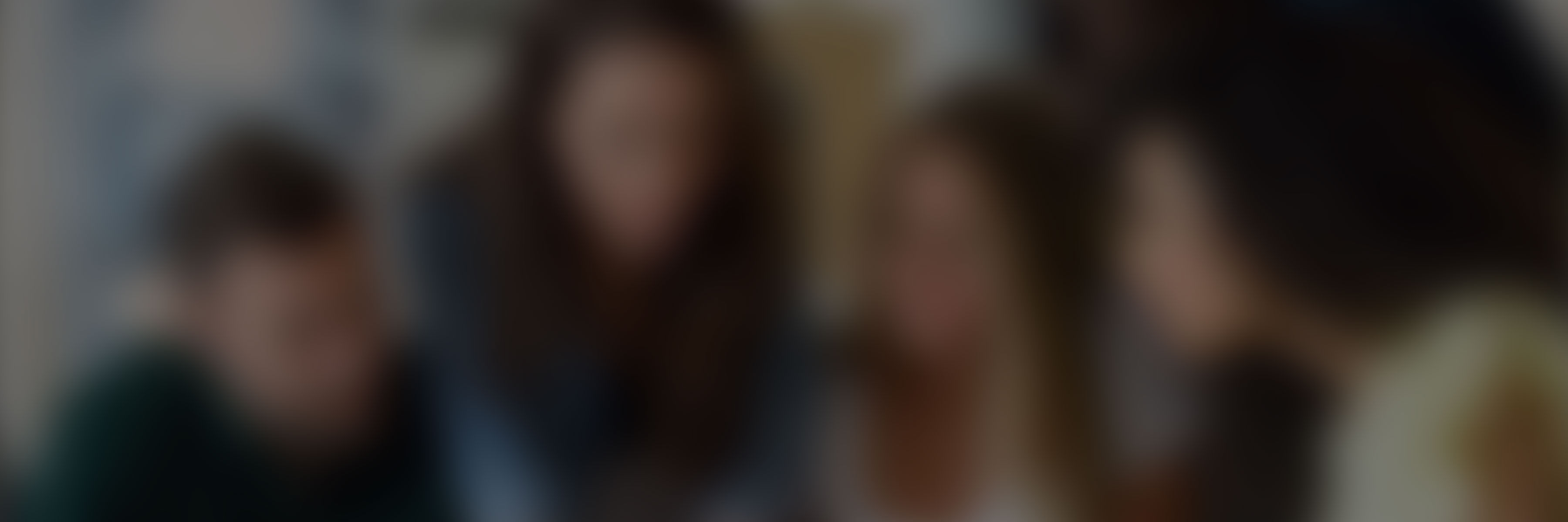 Higher education students working together at a desk with computer.