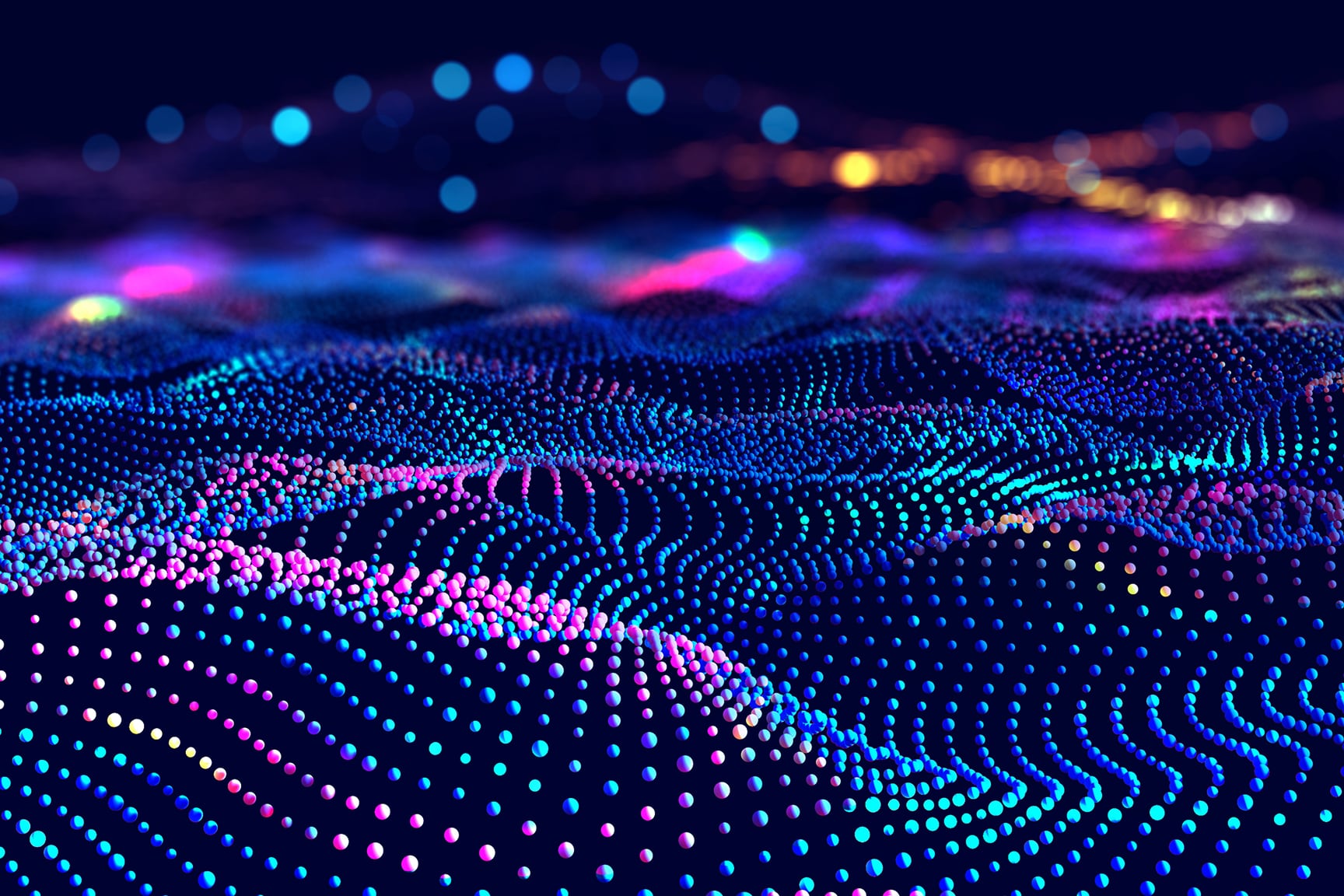A vibrant field of multicolored dots forms flowing wave-like patterns across a dark background