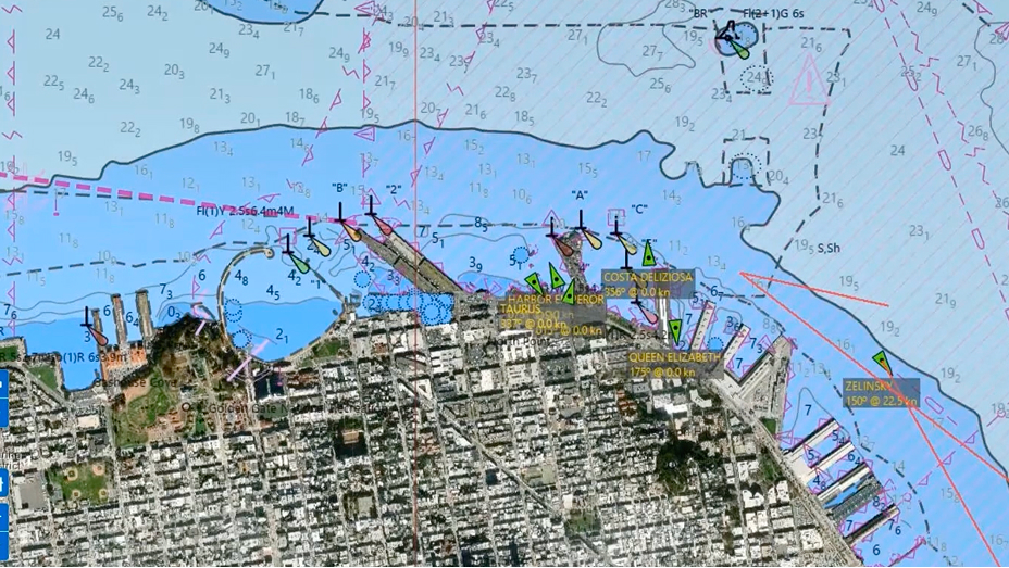 The image shows a detailed nautical chart overlaid on an aerial view of a coastal city and harbor