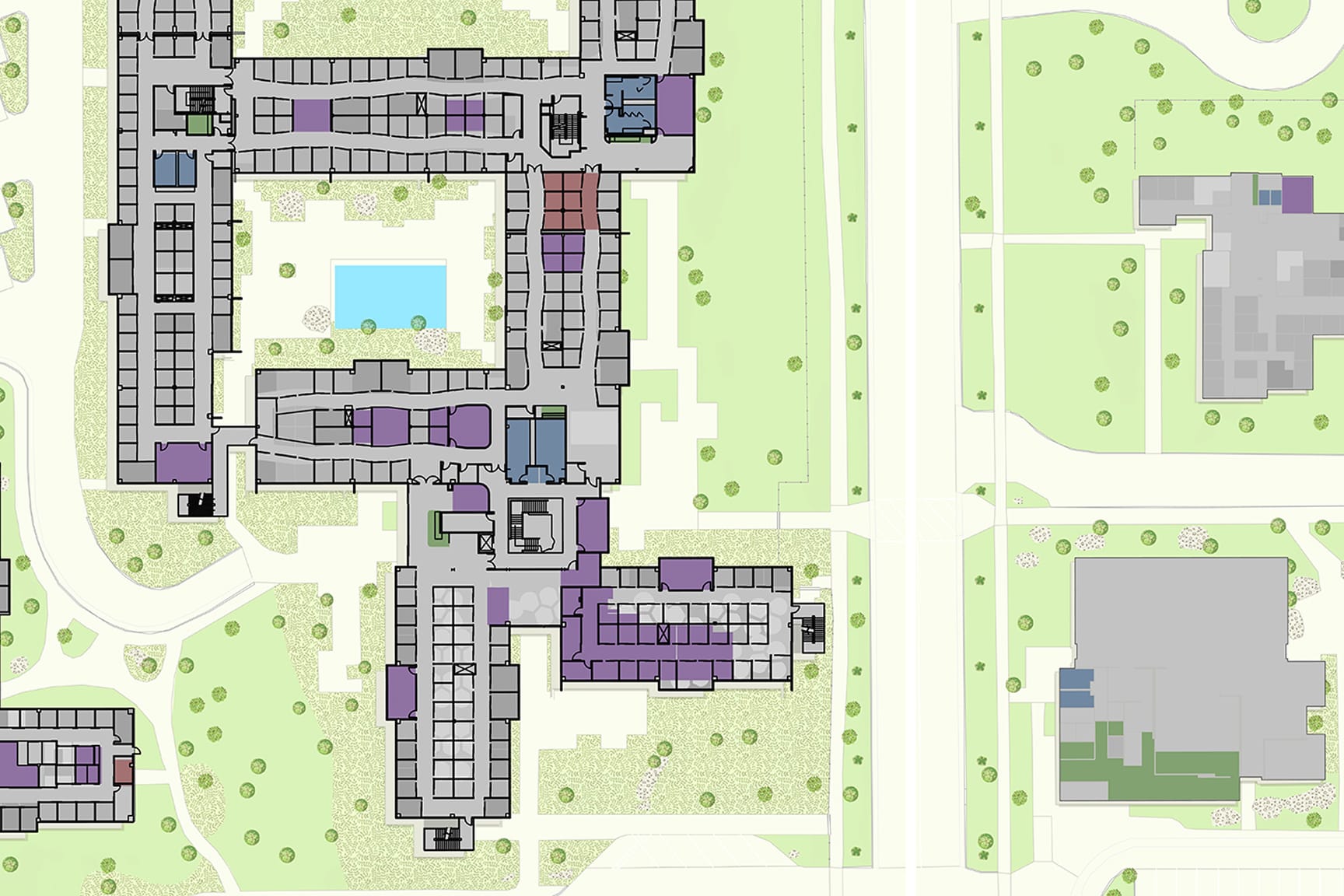 Detailed site plan showcasing a residential or institutional layout with multiple buildings and surrounding green spaces. 